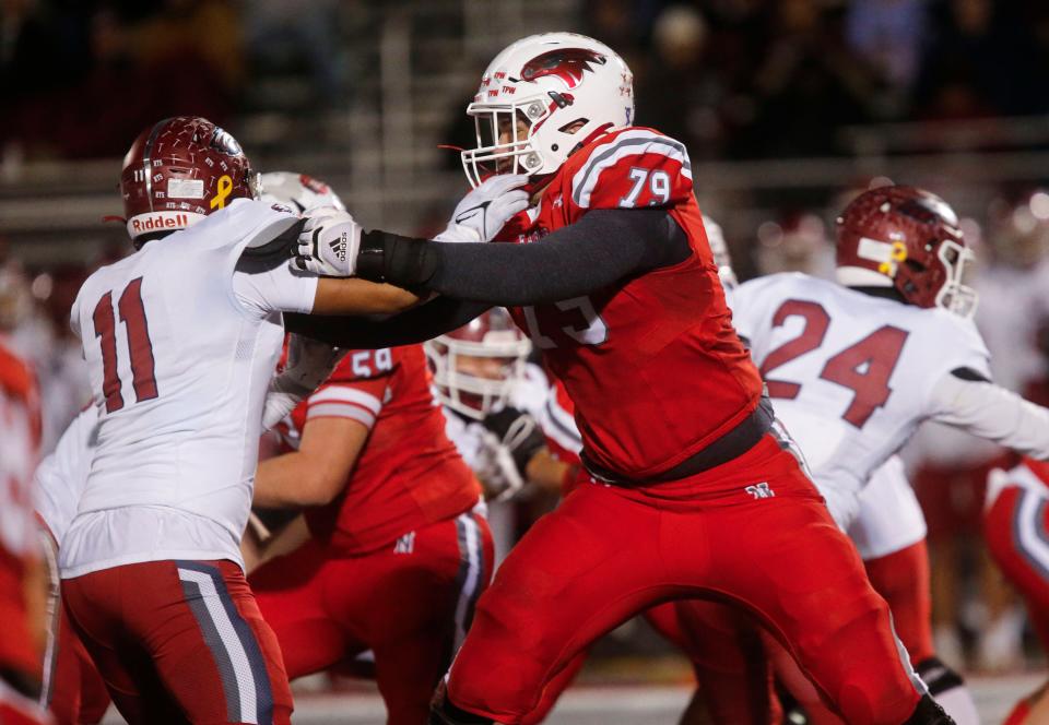 Nixa Eagles Jackson Cantwell holds back a Joplin defender during the championship game of Class 6 District 5 football at Nixa on Friday, Nov. 11, 2023.