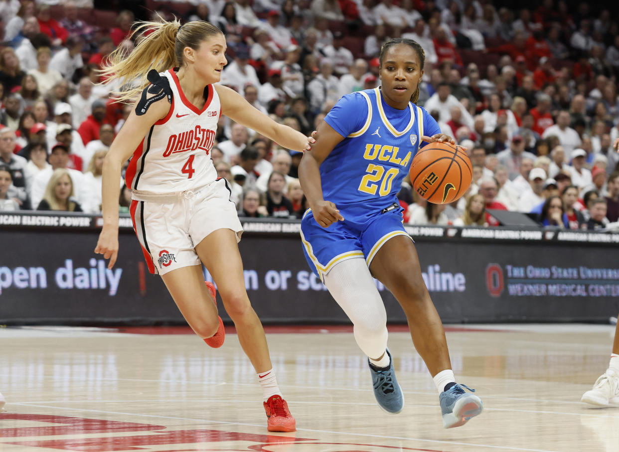 UCLA's Charisma Osborne tries to dribble past Ohio State's Jacy Sheldon during the first half of their game on Dec. 18, 2023, in Columbus, Ohio. (AP Photo/Jay LaPrete)