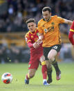 Wolverhampton Wanderers' Diogo Jota, centre, and Norwich City's Max Aarons in action during their English Premier League soccer match at Molineux stadium in Wolverhampton, England, Sunday Feb. 23, 2020. (Nick Potts/PA via AP)
