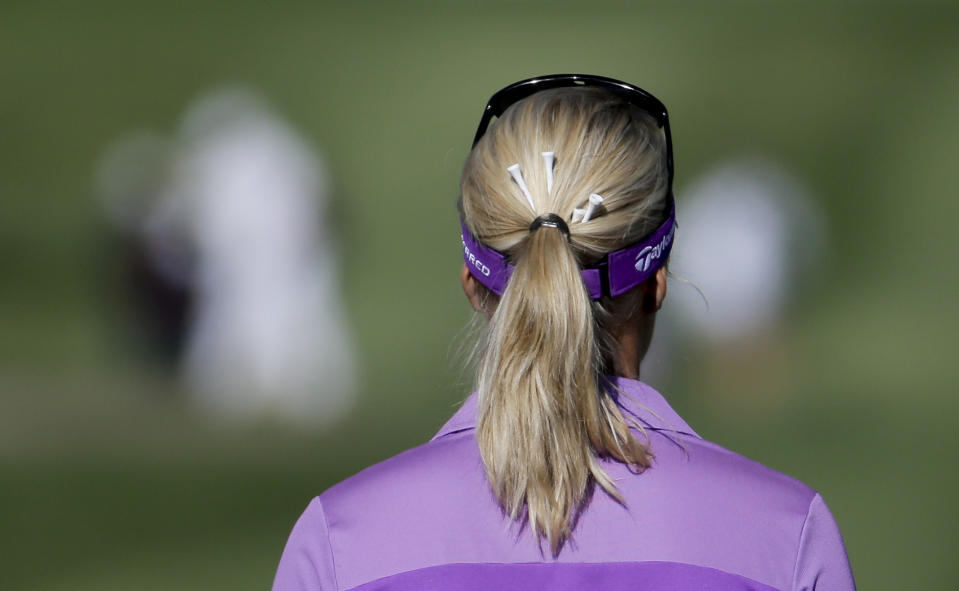 Anna Nordqvist, of Sweden, with golf tees in her hair, walks down the 15th fairway during the first round at the LPGA Kraft Nabisco Championship golf tournament Thursday, April 3, 2014, in Rancho Mirage, Calif. (AP Photo/Chris Carlson)