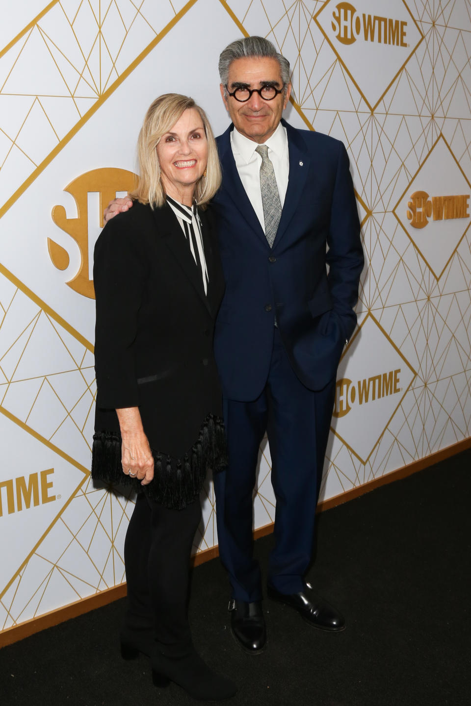 Eugene Levy poses next to wife Deborah Divine on red carpet