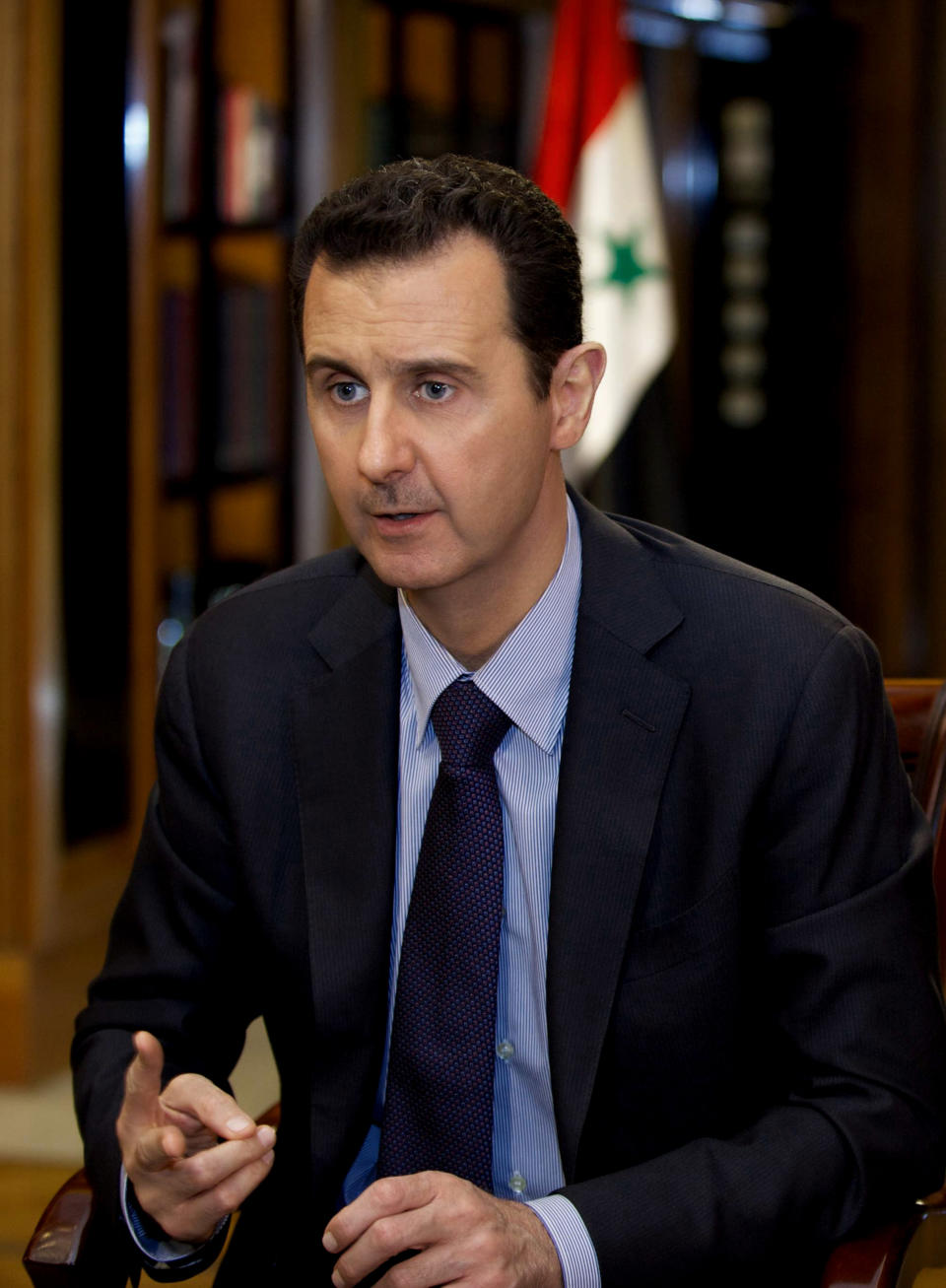 FILE - In this Monday, Oct. 21, 2013 file photo, which AP obtained from Syrian official news agency SANA and which has been authenticated based on its contents and other AP reporting, President Bashar Assad gestures as he speaks during an interview with Lebanon’s Al-Mayadeen TV, at the presidential palace in Damascus, Syria. With stakes high and expectations low, Syria's government and its opponents sit down face-to-face at an international peace conference this week for the first time _ muscled to the negotiating table by foreign powers that fear the bloodiest of the Arab Spring uprisings may engulf the entire region in sectarian war. (AP Photo/SANA, File)