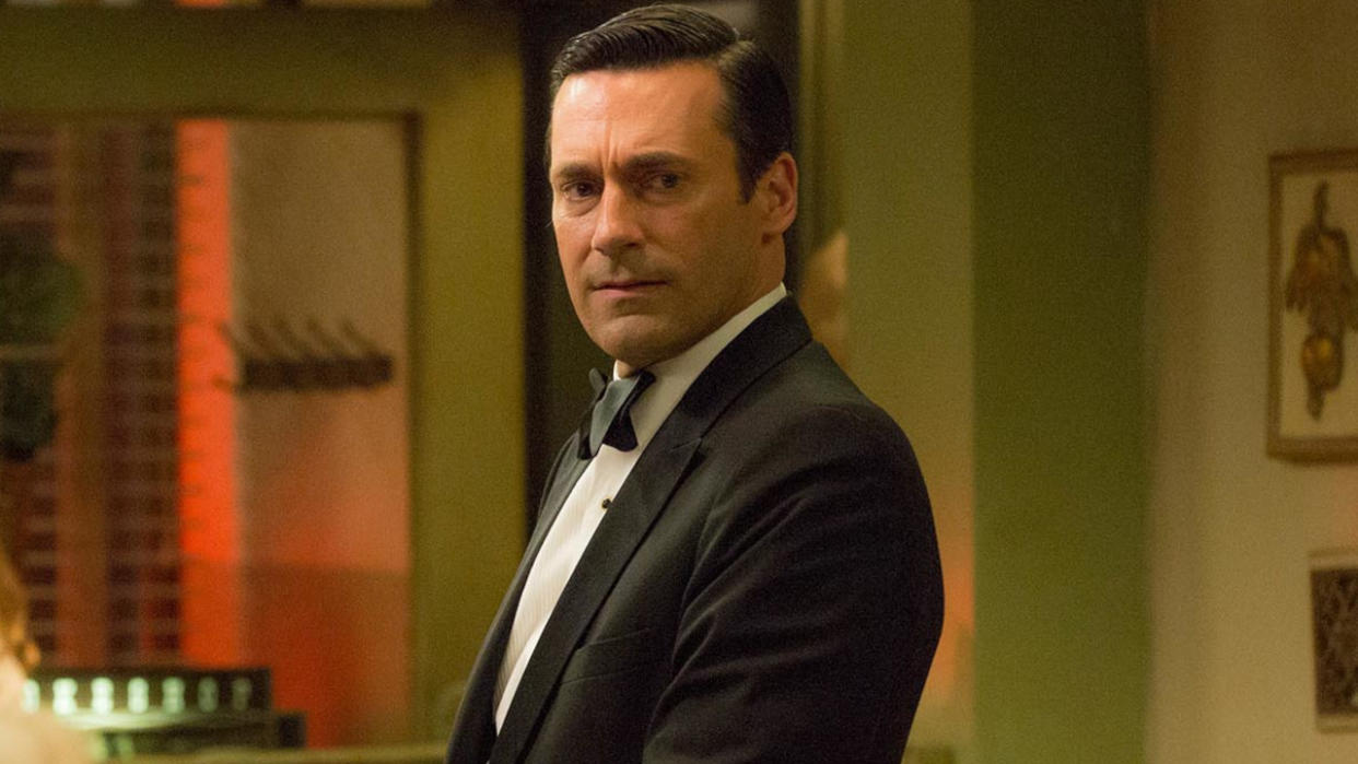  Jon Hamm standing in a tuxedo with a concerned look on his face, in Mad Men. 