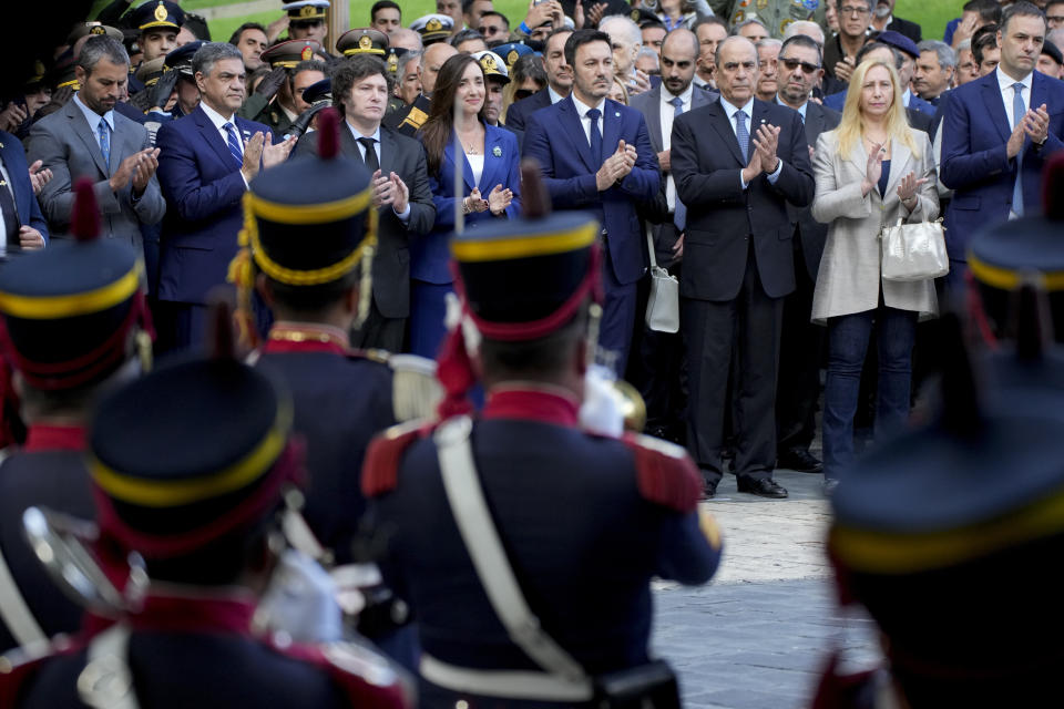 Argentine President Javier Milei, center left, and his Vice President Victoria Villarruel, center right, attend the official ceremony commemorating the 42nd anniversary of the conflict between Argentina and Great Britain over the Falkland Islands or Malvinas Islands at a war memorial in Buenos Aires, Argentina, Tuesday, April 2, 2024. (AP Photo/Natacha Pisarenko)