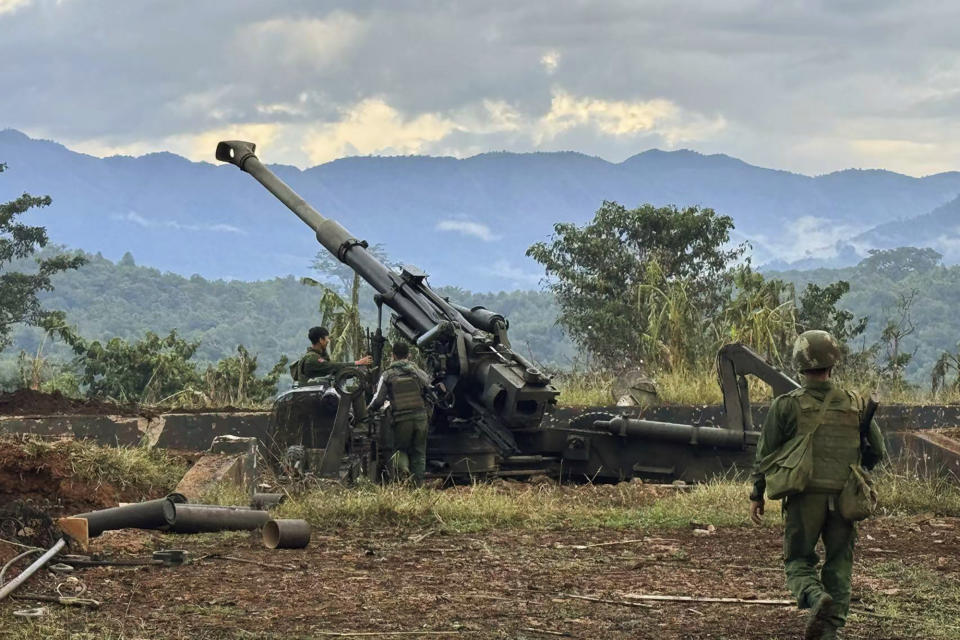 In this photo provided by the Kokang online media, members of an ethnic armed forces group, one of the three militias known as the Three Brotherhood Alliance, check weapons the group allegedly seized from Myanmar's army outpost on a hill in Hsenwi township in Shan state, Myanmar, on Nov. 24, 2023. A major offensive against Myanmar's military-run government by an alliance of three militias of ethnic minorities has been moving at lightning speed, inspiring resistance forces around the country to attack. (The Kokang online media via AP)