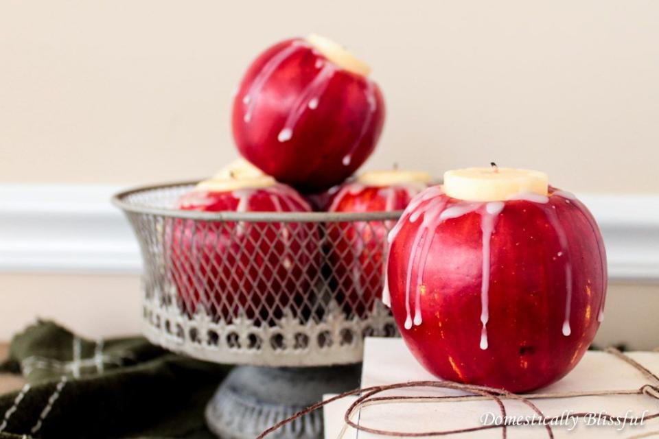 <p>Add an understated pop of color to your Thanksgiving table with these apple candleholders. Because this craft requires real apples, you'll also fill your house with a crisp fall aroma.</p><p><em><a href="http://domesticallyblissful.com/diy-apple-candle-holders/" rel="nofollow noopener" target="_blank" data-ylk="slk:Get the tutorial at Domestically Blissful »;elm:context_link;itc:0;sec:content-canvas" class="link ">Get the tutorial at Domestically Blissful »</a></em></p>