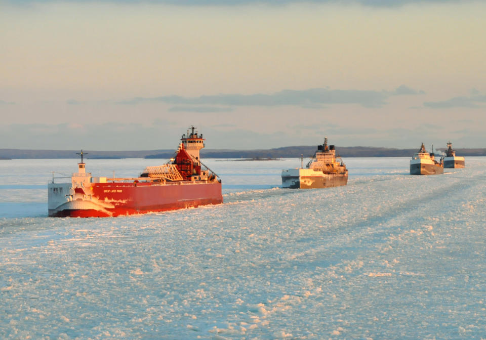 FILE - In this Jan. 9, 2014 file photo provided by the U.S. Coast Guard a convoy of Great Lakes cargo ships line up to follow an icebreaker on the St. Marys River, which links Lakes Superior and Huron. U.S. Steel said Monday, April 7, 2014 that its largest mill in Gary, Ind., is on limited production after a shortage of vital iron ore due to the ice covering Lake Superior had temporarily shut down its furnaces. (AP Photo/Lt. David Lieberman, File)