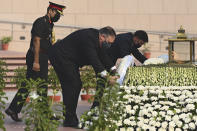 U.S. Secretary of State Mike Pompeo, left, and Secretary of Defence Mark Esper pay their tributes at the National War Memorial in New Delhi, India, Tuesday, Oct. 27, 2020. In talks on Tuesday with their Indian counterparts, Pompeo and Esper are to sign an agreement expanding military satellite information sharing and highlight strategic cooperation between Washington and New Delhi with an eye toward countering China. (Jewel Samad/Pool via AP)