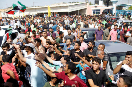 Palestinians celebrate as they wait for the arrival of Palestinian Prime Minister Rami Hamdallah and his government to take control of Gaza from the Islamist Hamas group, in the northern Gaza Strip October 2, 2017. REUTERS/Suhaib Salem