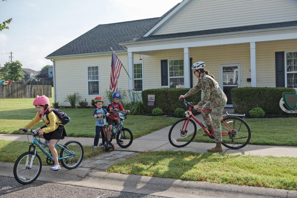 Erin Williams rides a bike with her kids (Tamara Reynolds for NBC News)