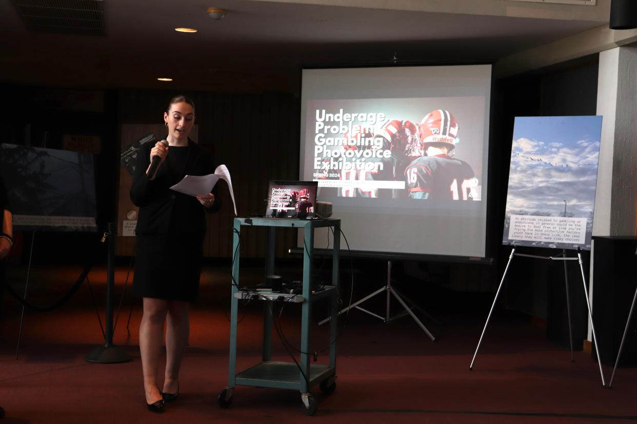 Cara Ferguson, prevention coordinator at the Brockton branch of High Point, speaks at the PhotoVoice ceremony in the Brockton High School fine arts lobby on April 24, 2024.