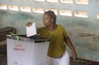 A woman cast her vote during the presidential election in Lome, Togo, Saturday, Feb. 22, 2020. The West African nation of Togo is voting Saturday in a presidential election that is likely to see the incumbent re-elected for a fourth term despite years of calls by the opposition for new leadership. (AP Photo/Sunday Alamba)
