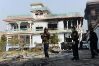 <p>Afghan security forces inspect the site of an attack by Islamic State militants at the British charity Save the Children compound in Jalalabad on Jan. 25, 2018. (Photo: Noorullah Shirzada/AFP/Getty Images) </p>