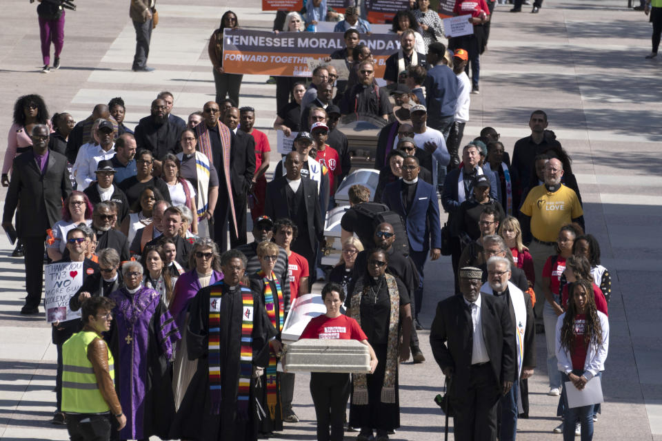 Demonstrators carry caskets to the state Capitol during a Tennessee Moral Monday rally against gun violence Monday, April 17, 2023, in Nashville, Tenn. (AP Photo/George Walker IV)