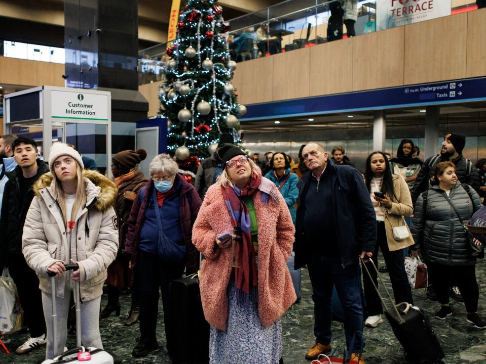 Passengers wait for train services to travel from Euston Station as they make their Christmas getaway in London (EPA)