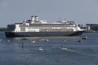 The cruise ship Rotterdam turns as it prepares to dock at Port Everglades, Thursday, April 2, 2020, in Fort Lauderdale, Fla. A cruise ship that has been floating at sea with coronavirus patients aboard for two weeks after being turned away from South American ports was finally allowed to dock in Florida. The Zaandam and a sister ship sent to help it, the Rotterdam, were both given permission to disembark passengers after days of negotiation with local officials who feared it would divert needed resources from a region that has seen a spike in virus cases. (AP Photo/Wilfredo Lee)