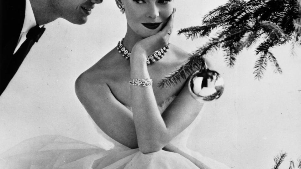 Model Susan Abraham poses beside a Christmas tree, December 1955.