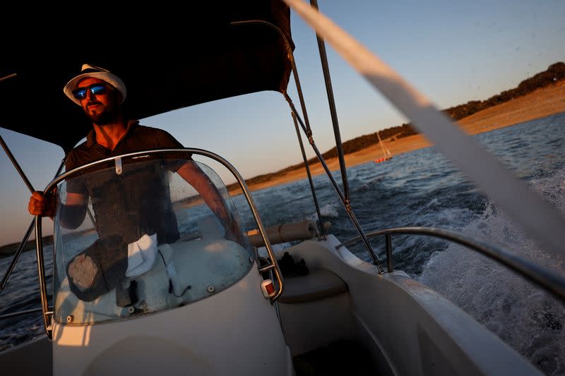 Ruben Argenta drives his boat towards the dolmen of Guadalperal