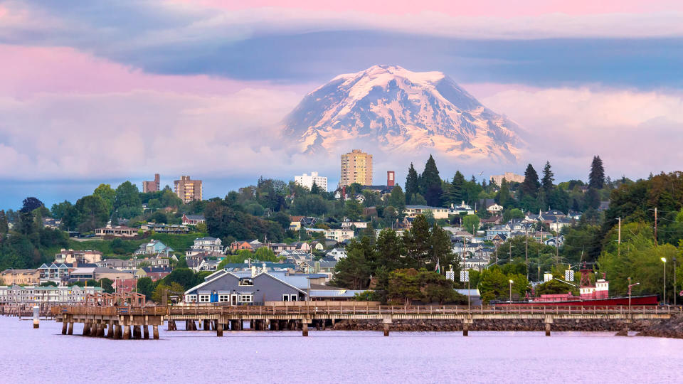 Mount Rainier over Tacoma Washington waterfront during alpenglow sunset evening.