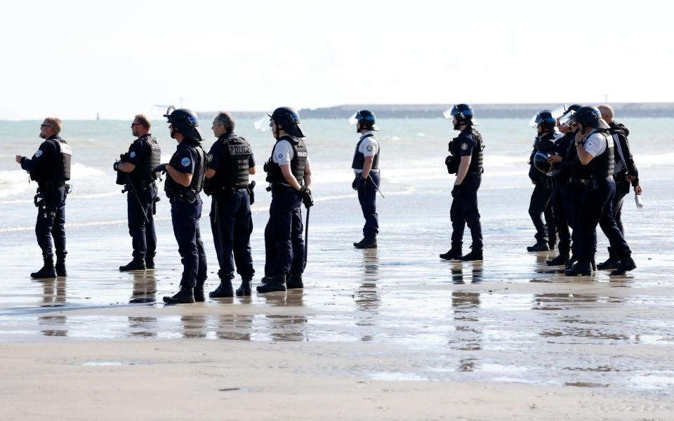 Officers look on as the migrants begin their Channel crossing