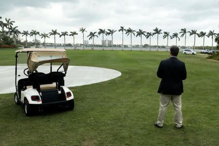 A Secret Service agent stands watch as U.S. President Donald Trump departs after spending the weekend at the Mar-a-Lago Club in Palm Beach, Florida, U.S. March 5, 2017. REUTERS/Jonathan Ernst