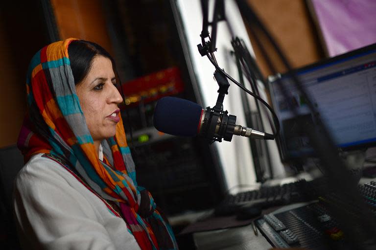 Afghan radio deejay Seema Safa talks on air during the "Safai Shahar" (Cleaning the City) show, in Kabul on June 10, 2014