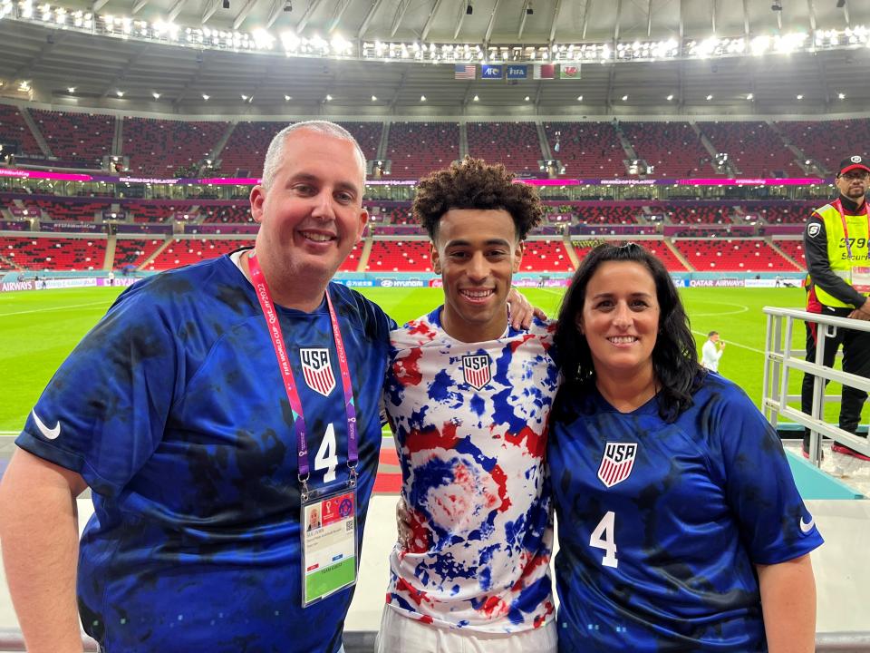 Tyler Adams, center, poses his parents, Darryl Sullivan Sr. and Melissa Russo, after the United States men's national soccer team tied Wales in a World Cup match Nov. 21, 2022 at Ahmad Bin Ali Stadium in Qatar.
