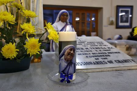 An image of Mother Teresa is seen on a candle used on Teresa's tomb during a special mass service in Kolkata, India, December 18, 2015. REUTERS/Rupak De Chowdhuri