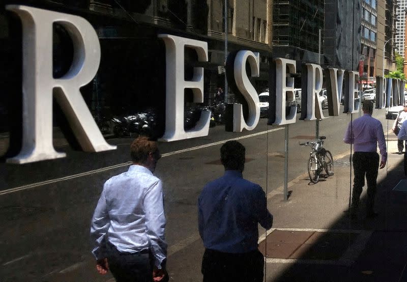 FILE PHOTO: Pedestrians walk past the Reserve Bank of Australia building in central Sydney