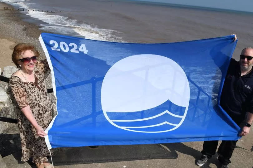 East Riding Council's Coastal Portfolio Holder Cllr Barbara Jefferson and the authority's Foreshore Inspector Jonathan Newman with the Blue Flag at Withernsea beach
