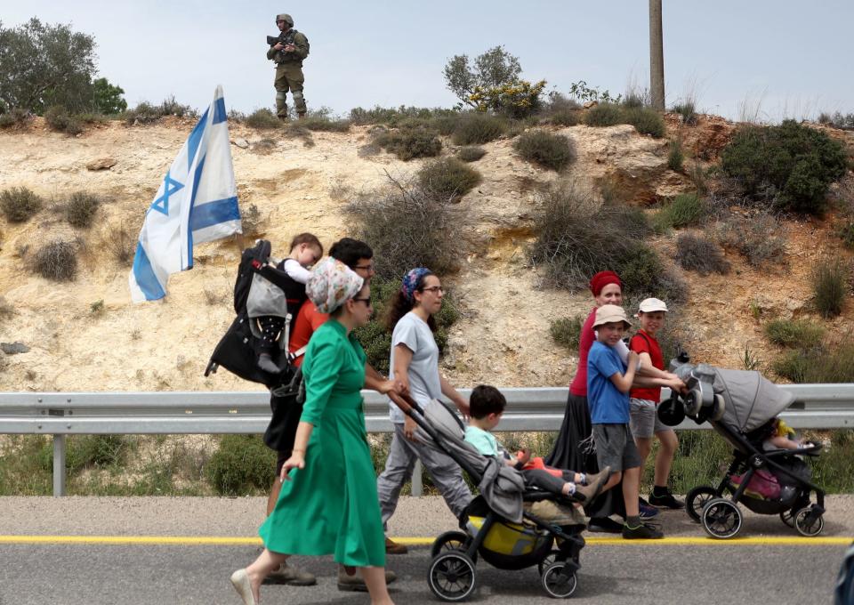 Israeli settlers hold a protest march from Tapuach Junction to the Israeli settler outpost of Evyatar, in the Israeli-occupied West Bank, April 10, 2023.