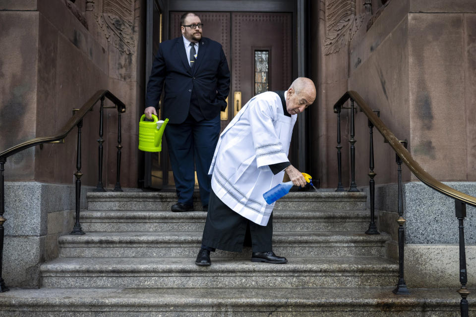 The stairs are cleaned ahead of a viewing for officer Richard Mendez at the Cathedral Basilica of Saints Peter and Paul in Philadelphia, Tuesday, Oct. 24, 2023. Mendez was shot and killed, and a second officer was wounded when they confronted people breaking into a car at Philadelphia International Airport, Oct. 12, police said. (AP Photo/Joe Lamberti)