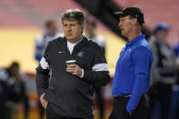 Washington State coach Mike Leach, left, and Air Force coach Troy Calhoun talk before the Cheez-It Bowl NCAA college football bowl game, Friday, Dec. 27, 2019, in Phoenix. (AP Photo/Rick Scuteri)