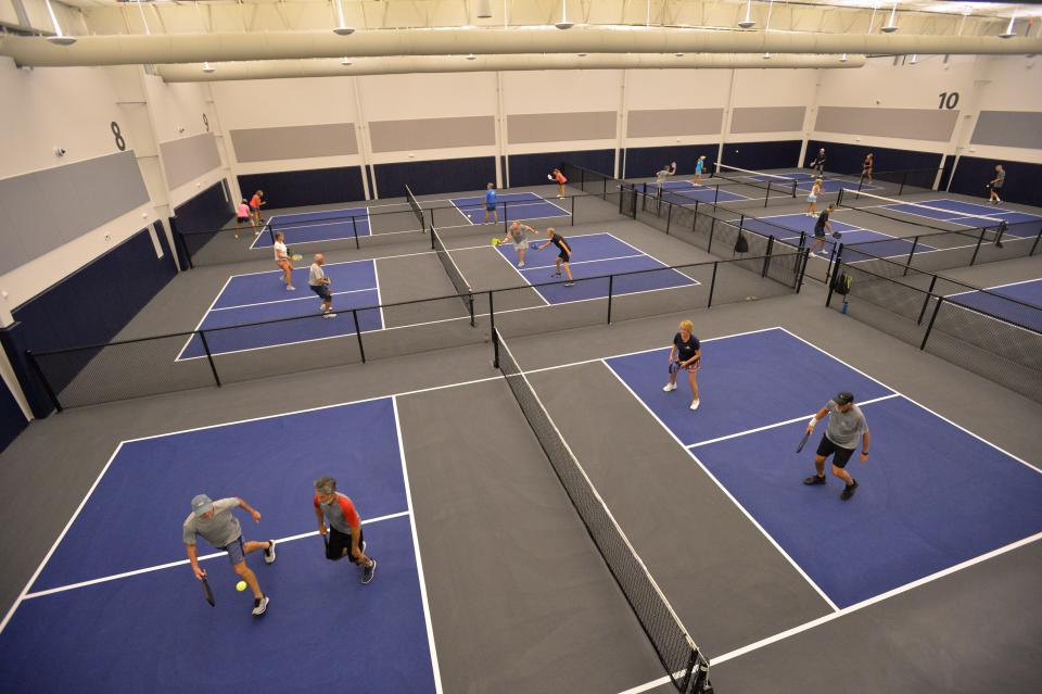 Pickleball has become an obsession for many people across the country. Participants are seen playing at the indoor Pickleball Club in Sarasota.