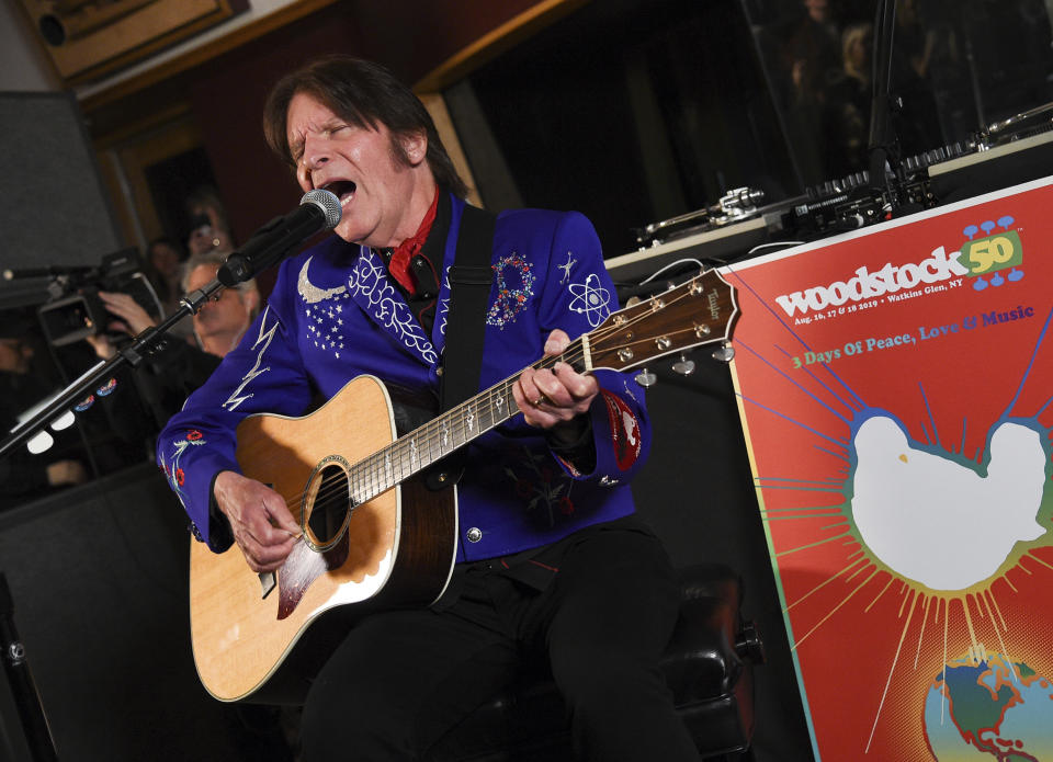 FILE - In this March 19, 2019, file photo, musician John Fogerty performs at the Woodstock 50 lineup announcement at Electric Lady Studios in New York. Fogerty has pulled out of Woodstock 50 weeks before the trouble anniversary event is supposed to take place. A representative for the singer tells The Associated Press that Fogerty, who performed at the original festival in 1969, will now only perform at a smaller Woodstock anniversary event held at the original site in Bethel, New York. (Photo by Evan Agostini/Invision/AP, File)