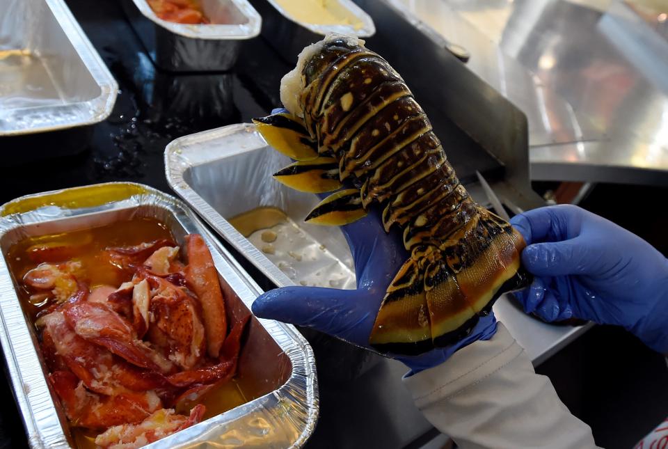 A lobster tail for a plate that includes seafood rice and chopped salad at Ocean Delight located inside the Nashville Farmers Market on Thursday, July 27, 2023, in Nashville, Tenn. Ocean Delight uses the test kitchen in the market house to operate. It is one of several kitchens around town that support local chefs trying to start their own businesses.