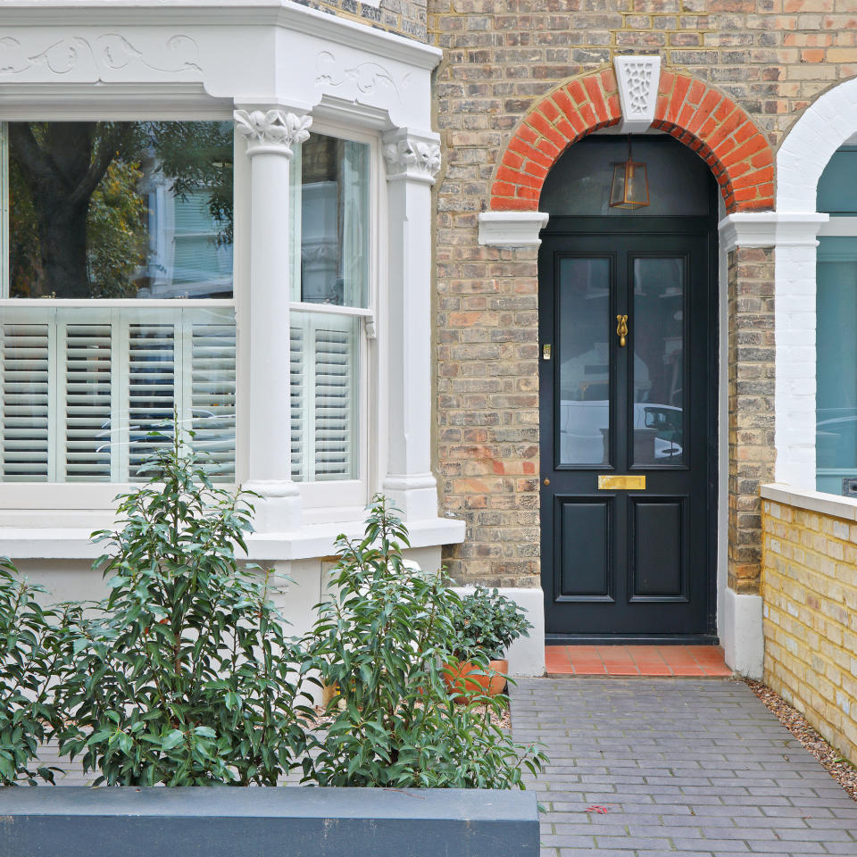 Victorian house exterior with bay window and cafe-style shutters