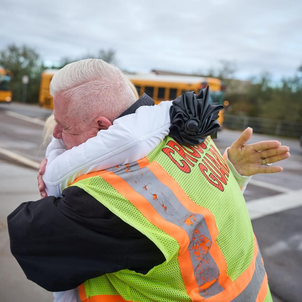 Walter Spano embraces Lisa Schneider outside of Payne Junior High School in Queen Creek on Dec. 12, 2022.