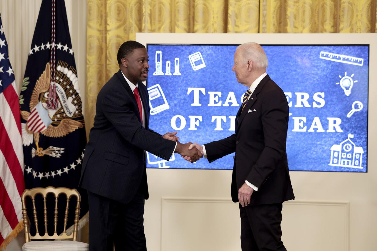U.S. President Joe Biden shakes hands with High School teacher Kurt Russell, the 2022 National Teacher of the Year, after Biden gave remarks during an event honoring the 2022 National and State Teachers of the Year in the East Room of the White House on April 27, 2022, in Washington, DC. Russell is a veteran history teacher from Oberlin High School in Oberlin, Ohio.