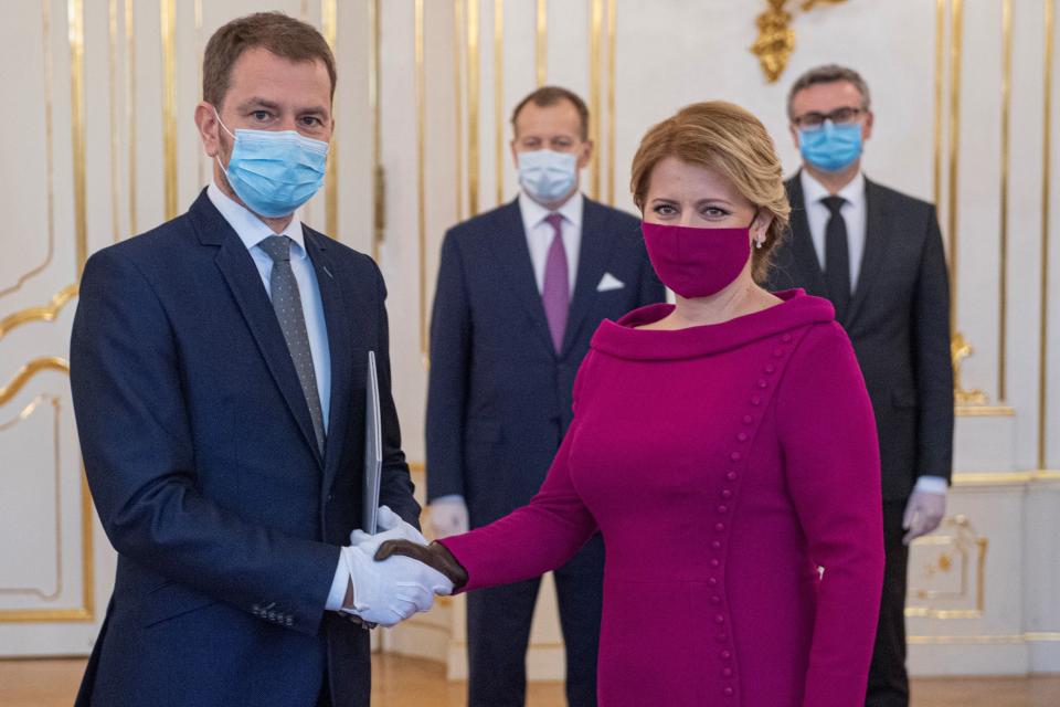 Newly appointed Slovak Prime Minister Igor Matovic (L), leader of the OLaNO anti-graft party shakes hands with President Zuzana Caputova during a swearing in ceremony of the new four-party coalition government on March 21, 2020 at the Presidential palace in Bratislava. - The ceremony was held without members of the press and all appointed government members wore gloves and face mask to prevent the spread of novel coronavirus. (Photo by Michal SVITOK / POOL / AFP) (Photo by MICHAL SVITOK/POOL/AFP via Getty Images)