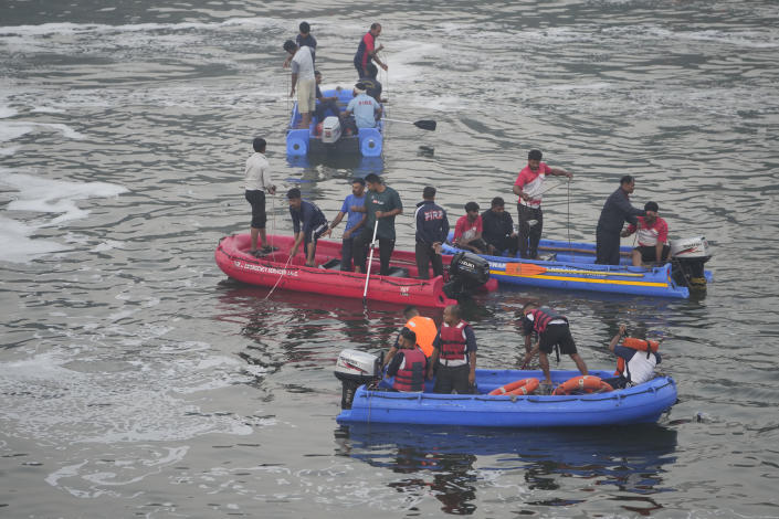 <p>Rescuers on boats search in the Machchu river next to a cable suspension bridge that collapsed in Morbi town of western state Gujarat, India, Monday, Oct. 31, 2022. The century-old cable suspension bridge collapsed into the river Sunday evening, sending hundreds plunging in the water, officials said. (AP Photo/Ajit Solanki)</p> 