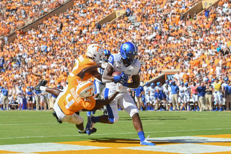 Georgia State receiver Cornelius McCoy (83) hauls in a touchdown catch against Tennessee defenders Warren Burrell (4) and Shawn Shamburger (12).