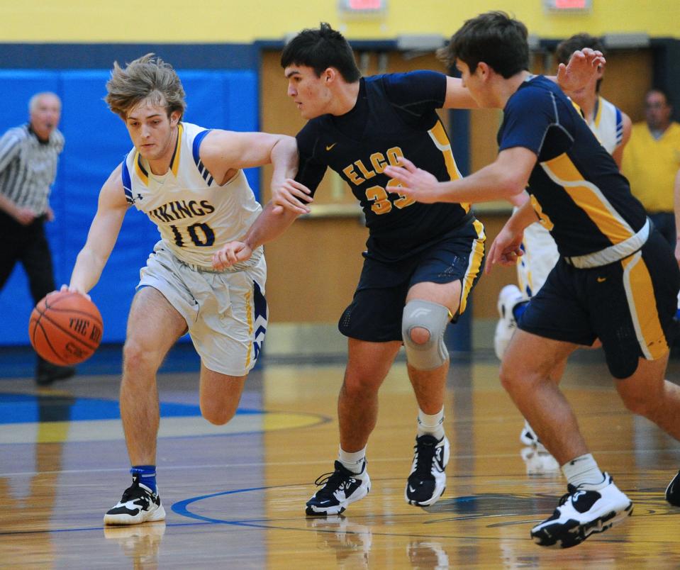 Northern Lebanon's Simon Grimes (10) tries to get around Elco's Rheece Shuey (33) during first quarter action Tuesday at Northern Lebanon. Northern Lebanon aided county rival Elco's section title hopes by upsetting Lancaster Catholic Tuesday night.