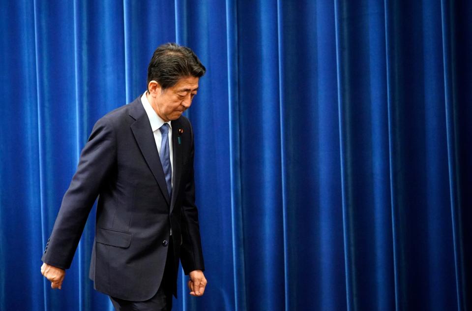 Japanese prime minister Shinzo Abe walks after delivering a press conference at the prime minister official residence in Tokyo, Japan, 28 August 2020 (EPA)
