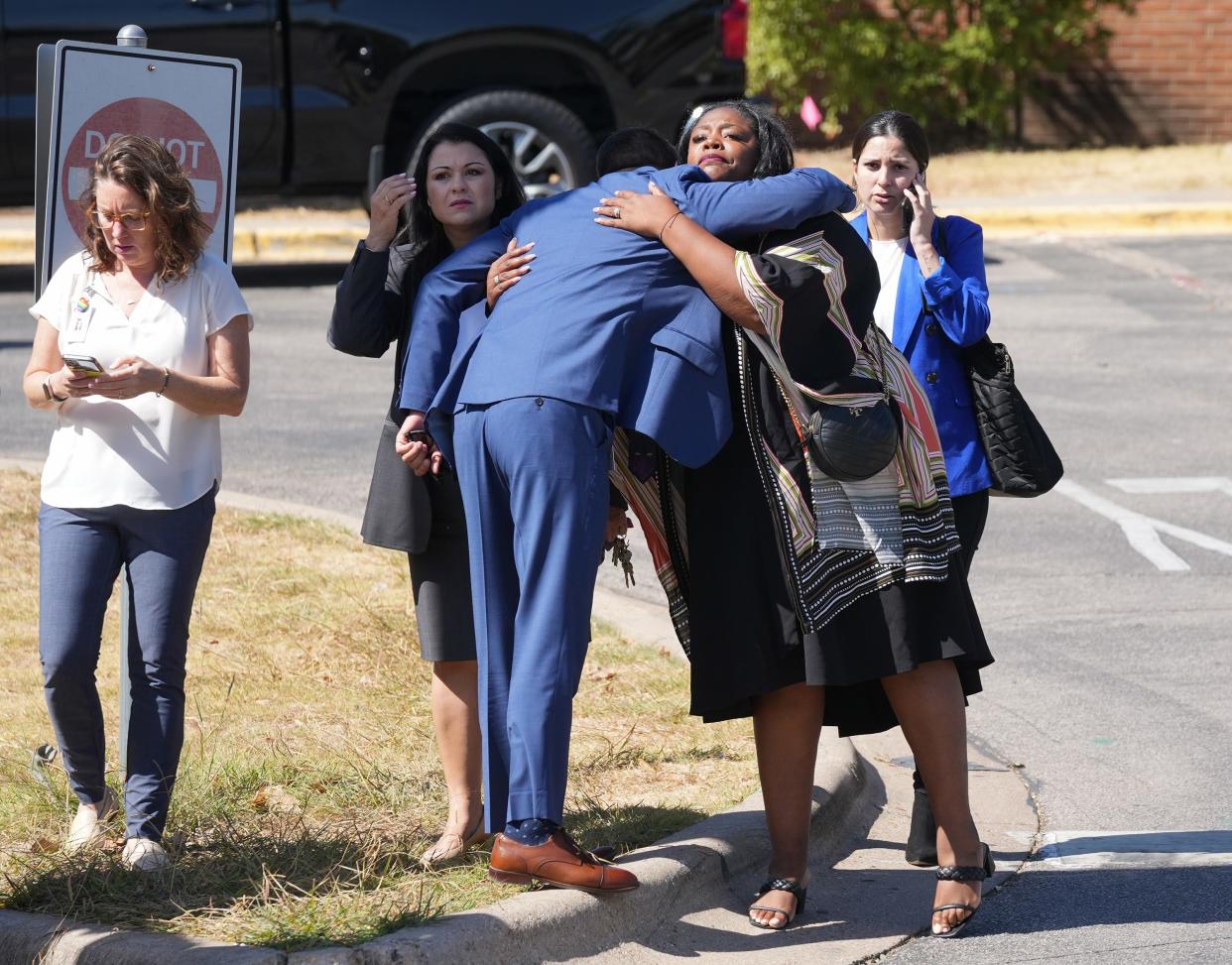 Austin interim school Superintendent Matias Segura hugs Assistant Superintendent Lakesha Drinks after a student's body was found outside Travis Early College High School on Thursday morning. Police say there is no threat to the public.