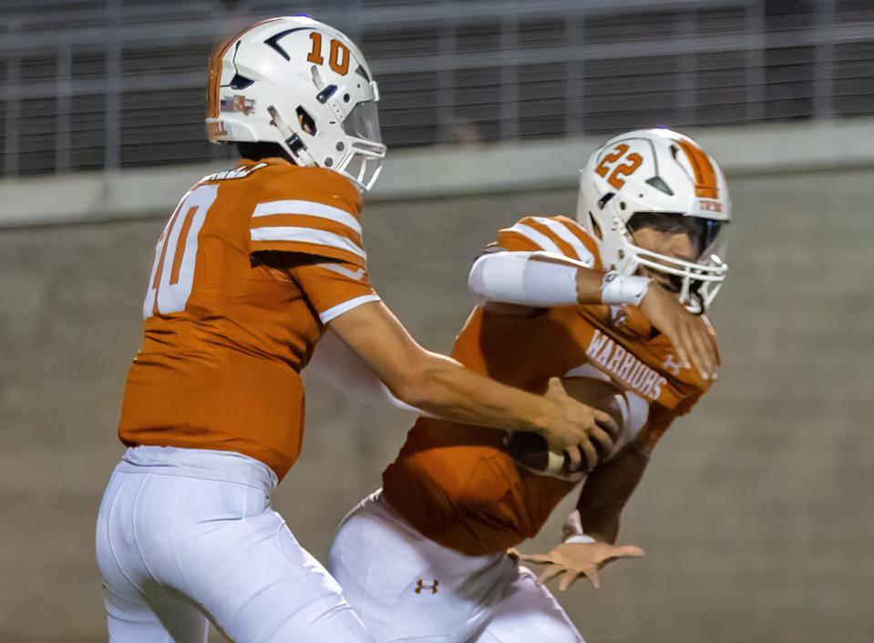 Westwood quarterback Owen Norrell hands the ball to running back Ananias Vance, who finished with 149 yards and a score.