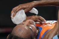 Sifan Hassan, of Netherlands, places a bag of ice on her face after winning the women's 10,000-meters final at the 2020 Summer Olympics, Saturday, Aug. 7, 2021, in Tokyo. (AP Photo/Petr David Josek)