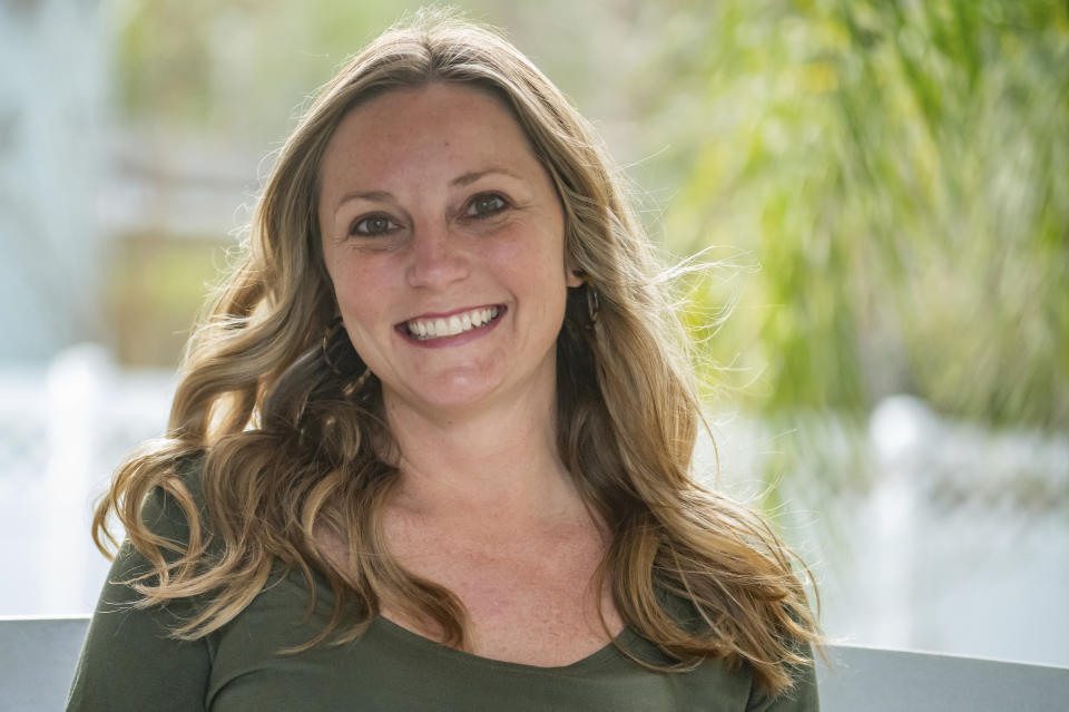 Holly Nover sits on a backyard swing at her home Wednesday, Feb. 16, 2022, in St. Johns, Fla. Nover grew up trying to hide her stutter. “I was very self conscious,” said the 40-year-old St. Johns, Florida mom, whose 10-year-old son also has a speech impediment. “So I developed habits to switch my words so it wouldn’t be noticed.” (AP Photo/Fran Ruchalski)