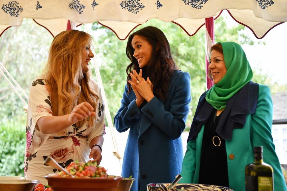 Meghan helps prepare food with women affected by the Grenfell disaster (AFP/Getty Images)