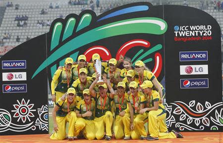 Australia's players celebrate with the winner's trophy after they won the ICC Twenty20 Women's World Cup title at the Sher-E-Bangla National Cricket Stadium in Dhaka April 6, 2014. REUTERS/Andrew Biraj